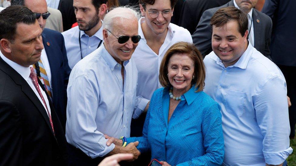 President Joe Biden poses for photographs with Speaker of the House Nancy Pelosi and other guests during the Congressional Picnic on the South Lawn of the White House