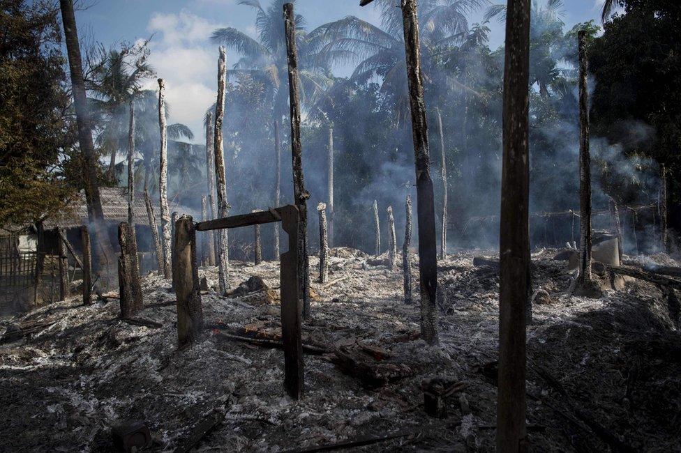 Smouldering debris of burned houses is seen in Warpait, a Muslim village in Maungdaw located in Myanmar's Rakhine State, 14 October