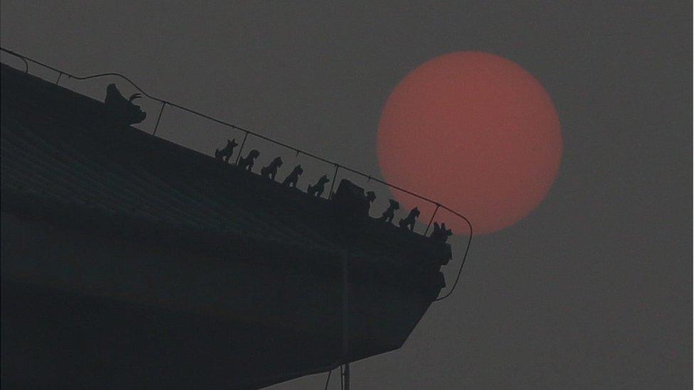 The sun is (barely) seen through smog in Beijing on 22 December