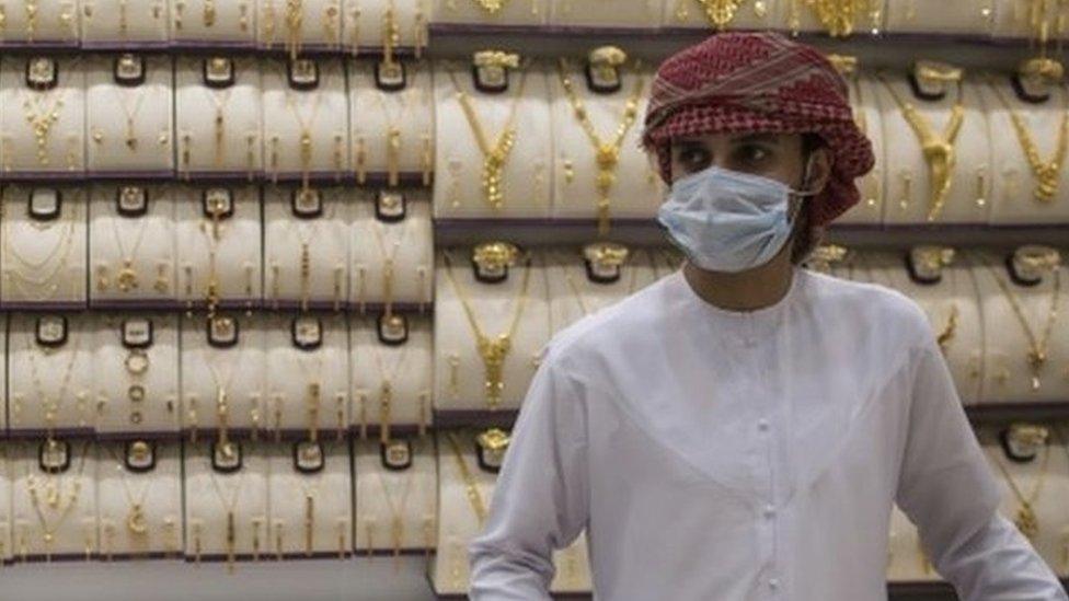 A seller wears a protective mask in a gold shop at Dubai Gold Market, Dubai