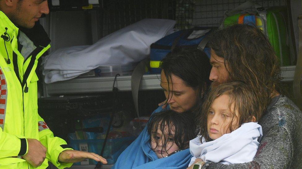 A family is rescued after their boat capsized as they were being evacuated from a flooded property at Upper Colo in north western Sydney,