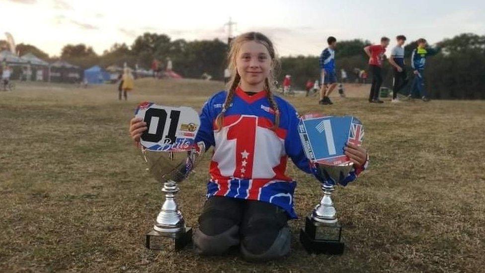 Amelie Eaton posing with her trophies