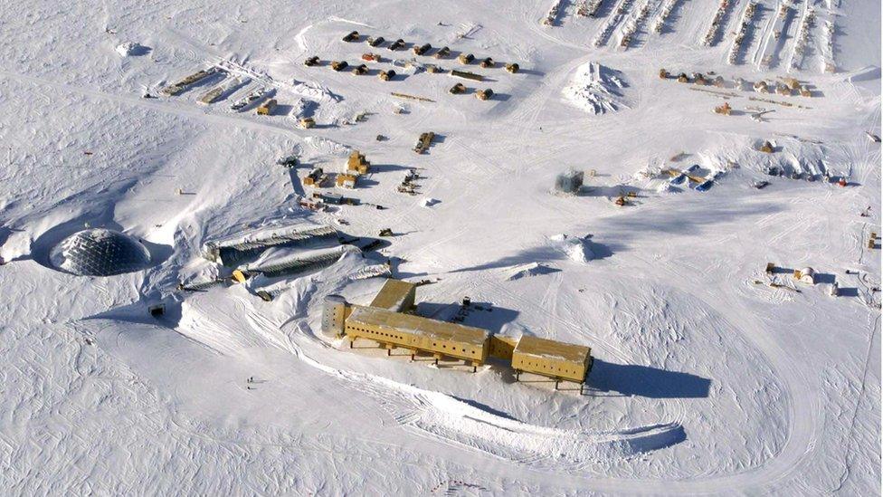 a view from high above of buildings in the snow