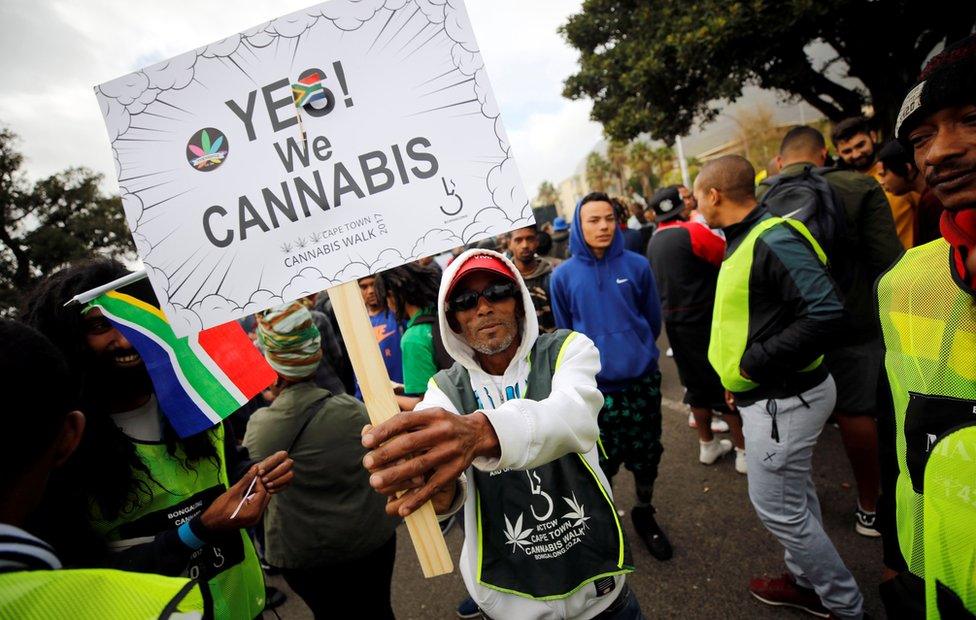 A demonstrator holds a placard during a march calling for the legalisation of cannabis, known locally as dagga, in Cape Town, South Africa