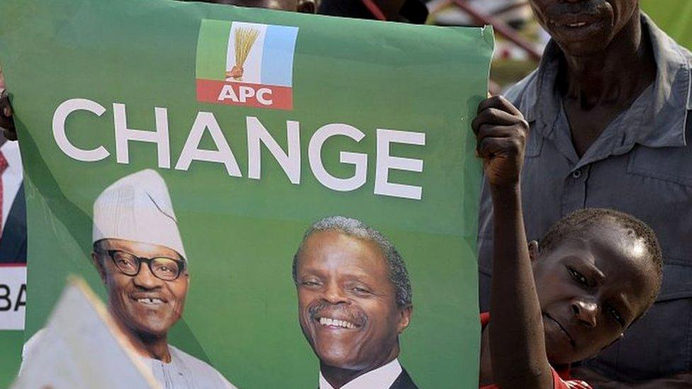 Boy holding a poster which says change