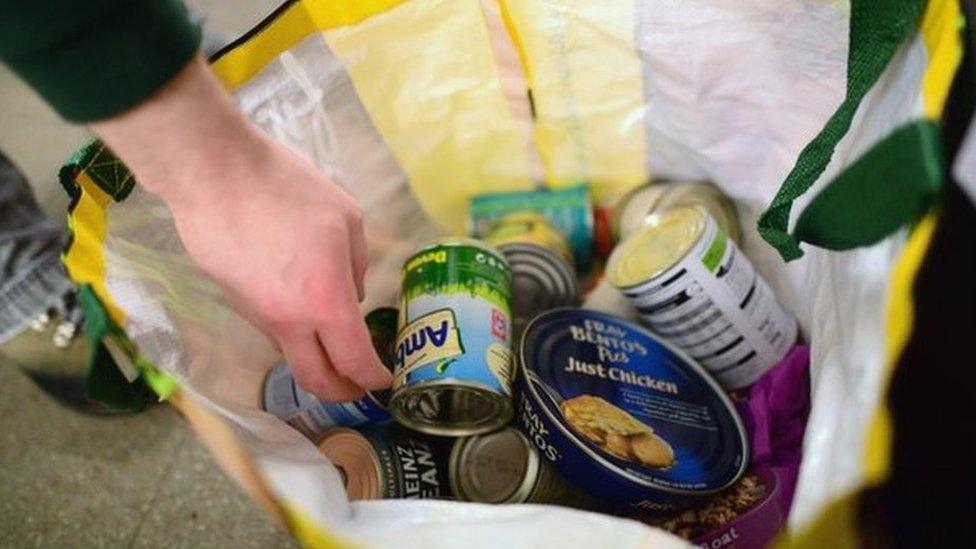 A volunteer packs food at a food bank