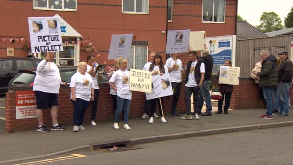 A gathering of protestors outside a care home