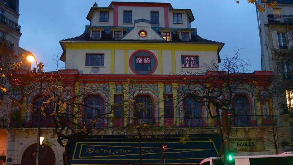 People walk past the Bataclan concert hall in Paris