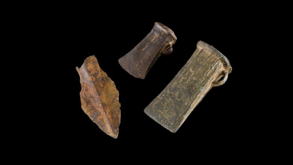 bronze axe heads and spear head.