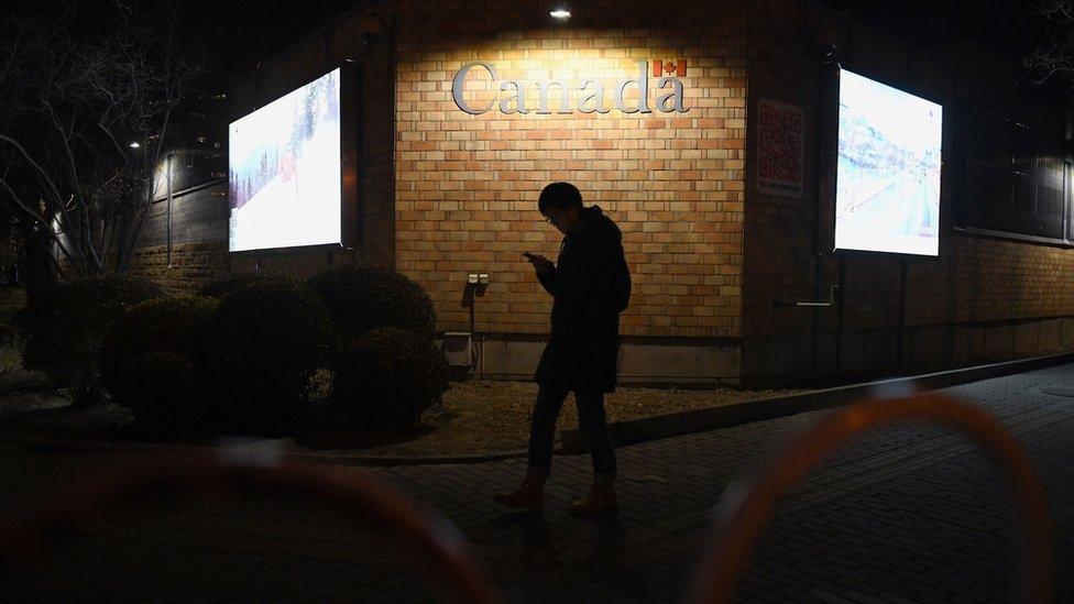 A man walks past the Canadian embassy in Beijing