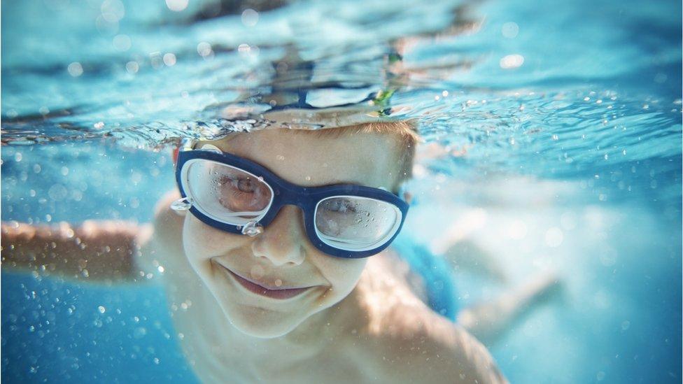 Young boy swimming in a pool