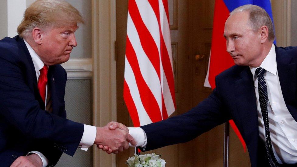 Donald Trump and Vladimir Putin shake hands