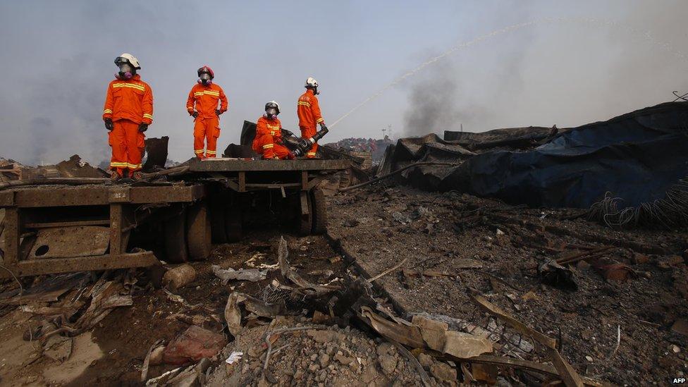 Firefighters work at the site of the explosions