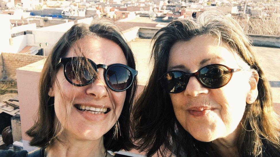 Two women in sunglasses on a rooftop in Morocco