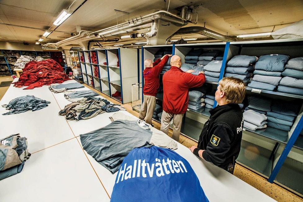 Prisoners sort through the laundry.