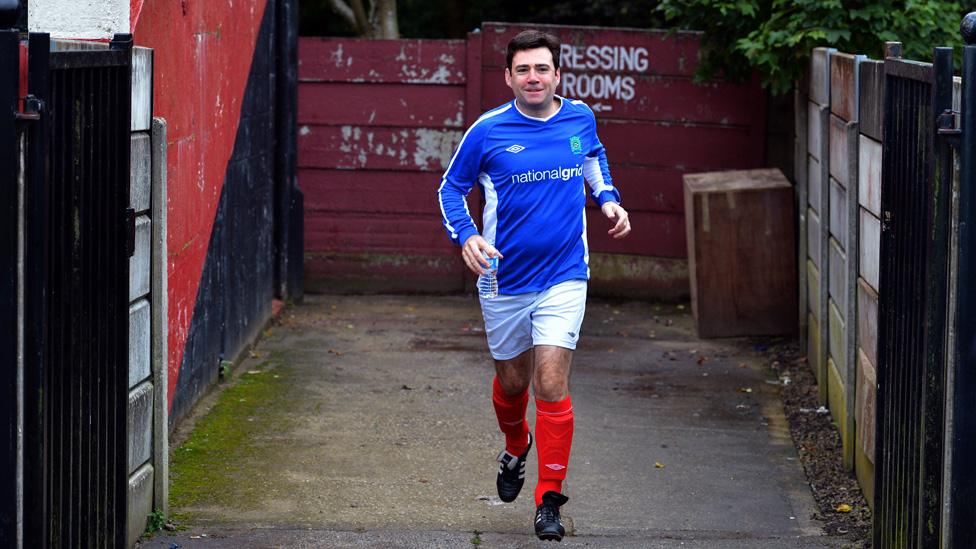 Andy Burnham running in football kit