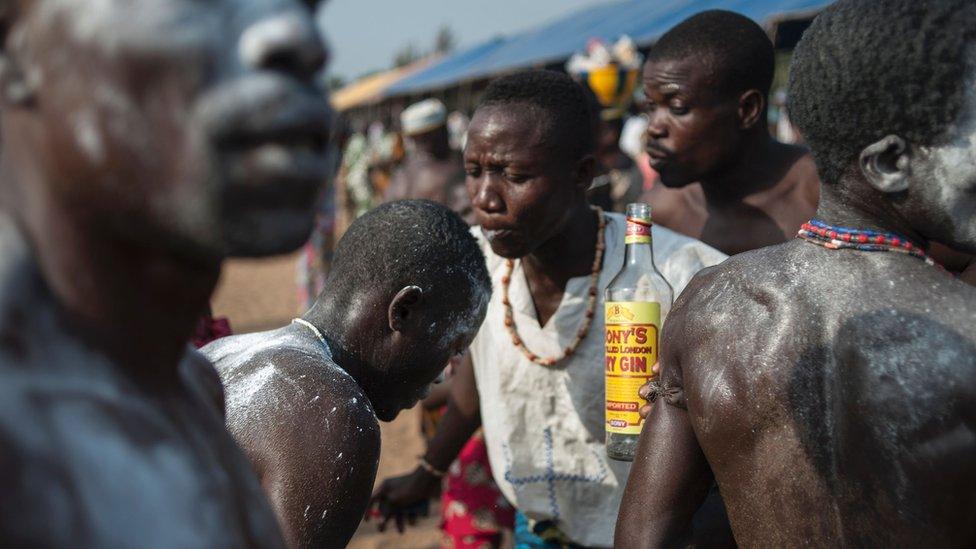 A man spits gin on a dancer to chase away bad spirits