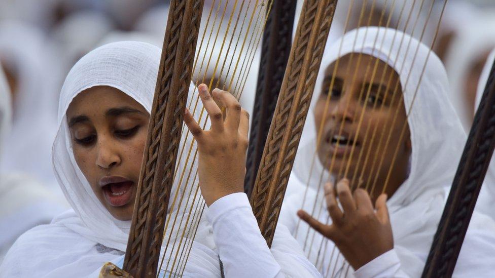 Believers play instruments during the Meskel celebrations, a religious holiday held by the Ethiopian Orthodox Church in Addis Ababa, on September 27, 2019.