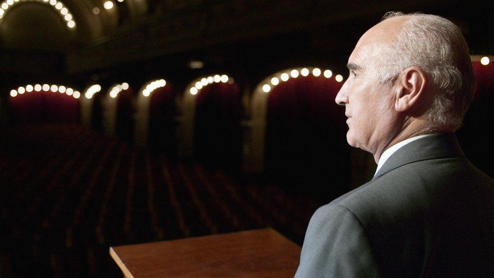 man in empty theatre