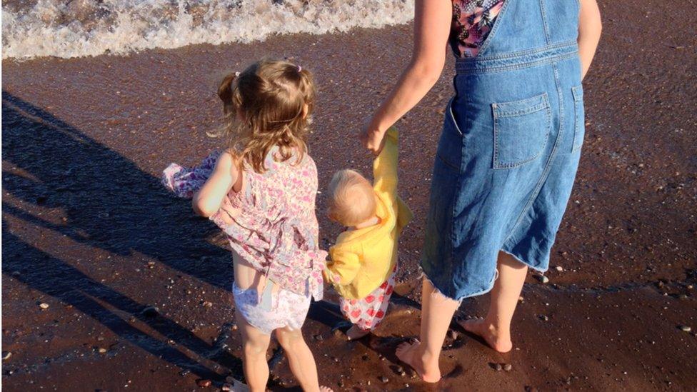 Molly with her two children at the beach