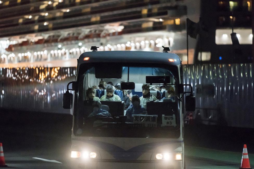 A bus carrying passengers, who will board the Qantas aircraft chartered by the Australian government, from the quarantined Diamond Princess cruise ship drive near Daikoku Pier on 19 February 2020 in Yokohama, Japan.