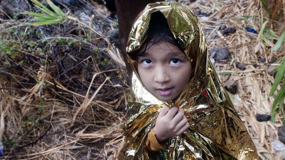 A child in a safety blanket after arriving on Lesbos (23 Sept)