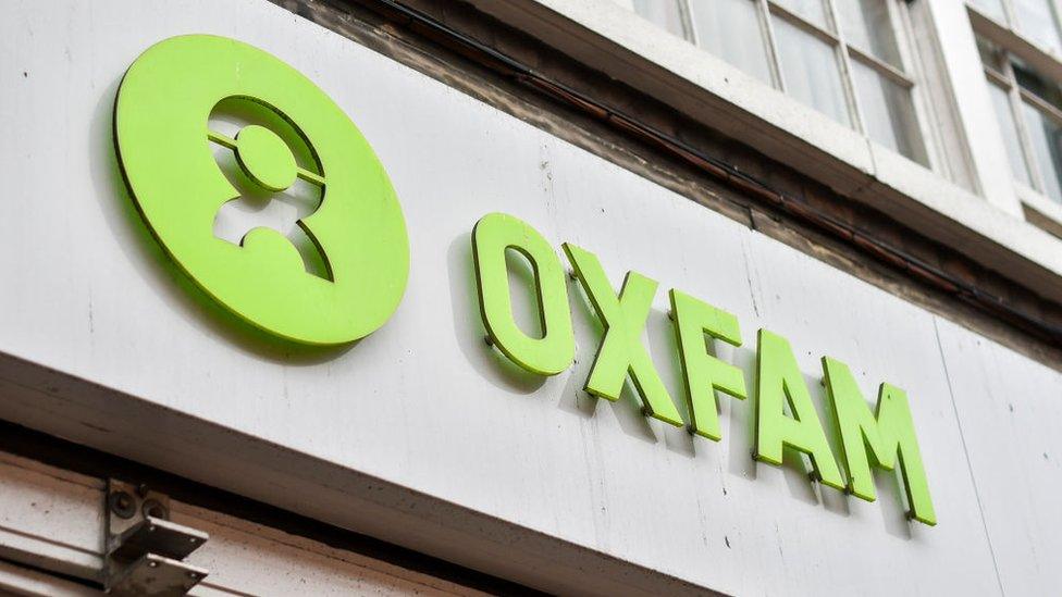 An Oxfam sign is pictured outside a charity bookshop in central London on February 13, 2018.