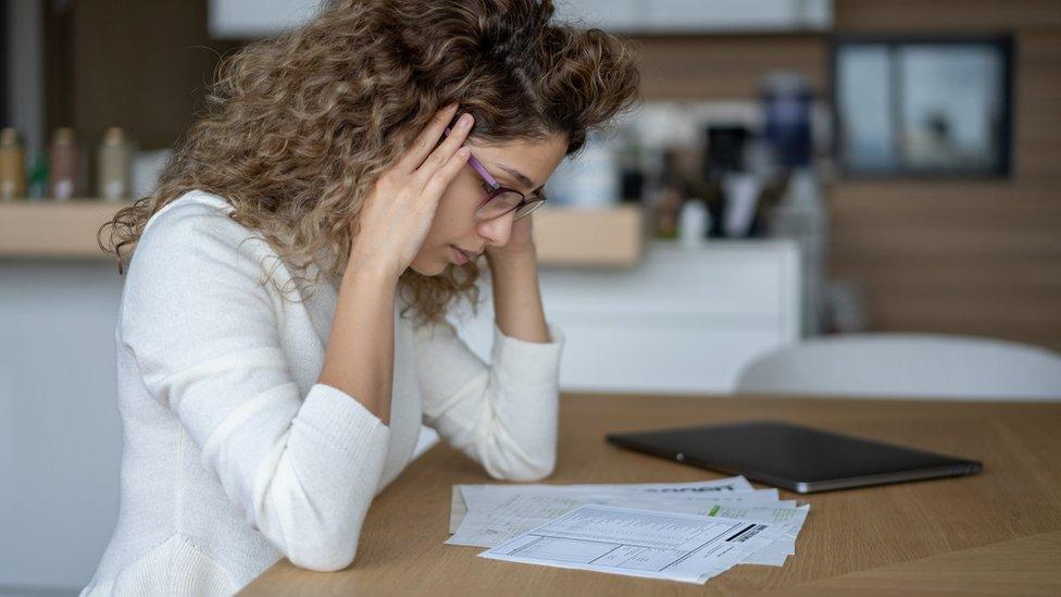 Woman looking at energy bill