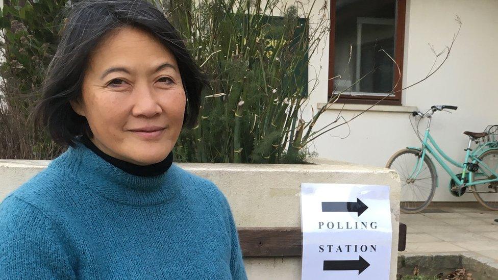 Woman sat outside polling station