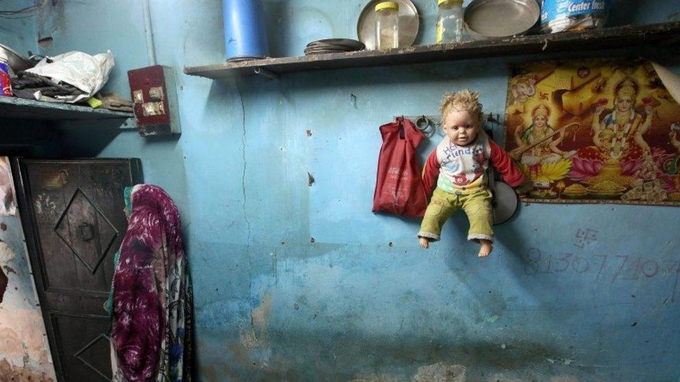 A doll hangs on a wall at the home of a four-year-old rape victim in a slum area, New Delhi, India, 14 October 2015