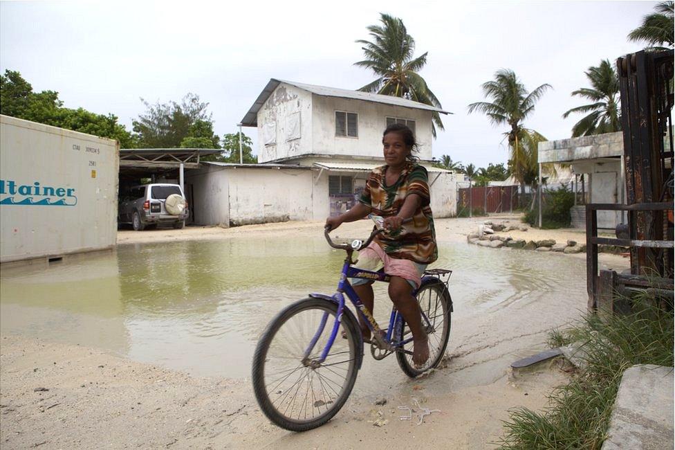 Picture of woman cycling on Tarawa in Kiribati