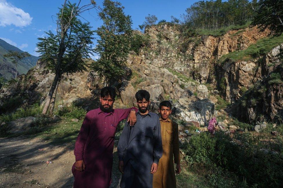 A shepherd, Liaqat Khan (C) seen with his relatives on the outskirts of Srinagar.