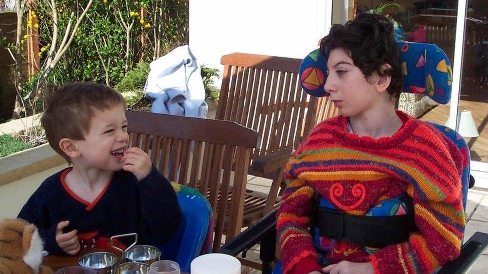 Josephine at a table with her younger brother