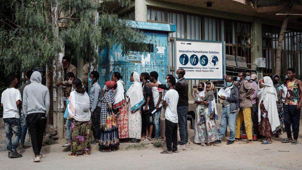 People wait in a line to enter a bank in Mekele, the capital of Tigray region, Ethiopia, on June 25, 2021