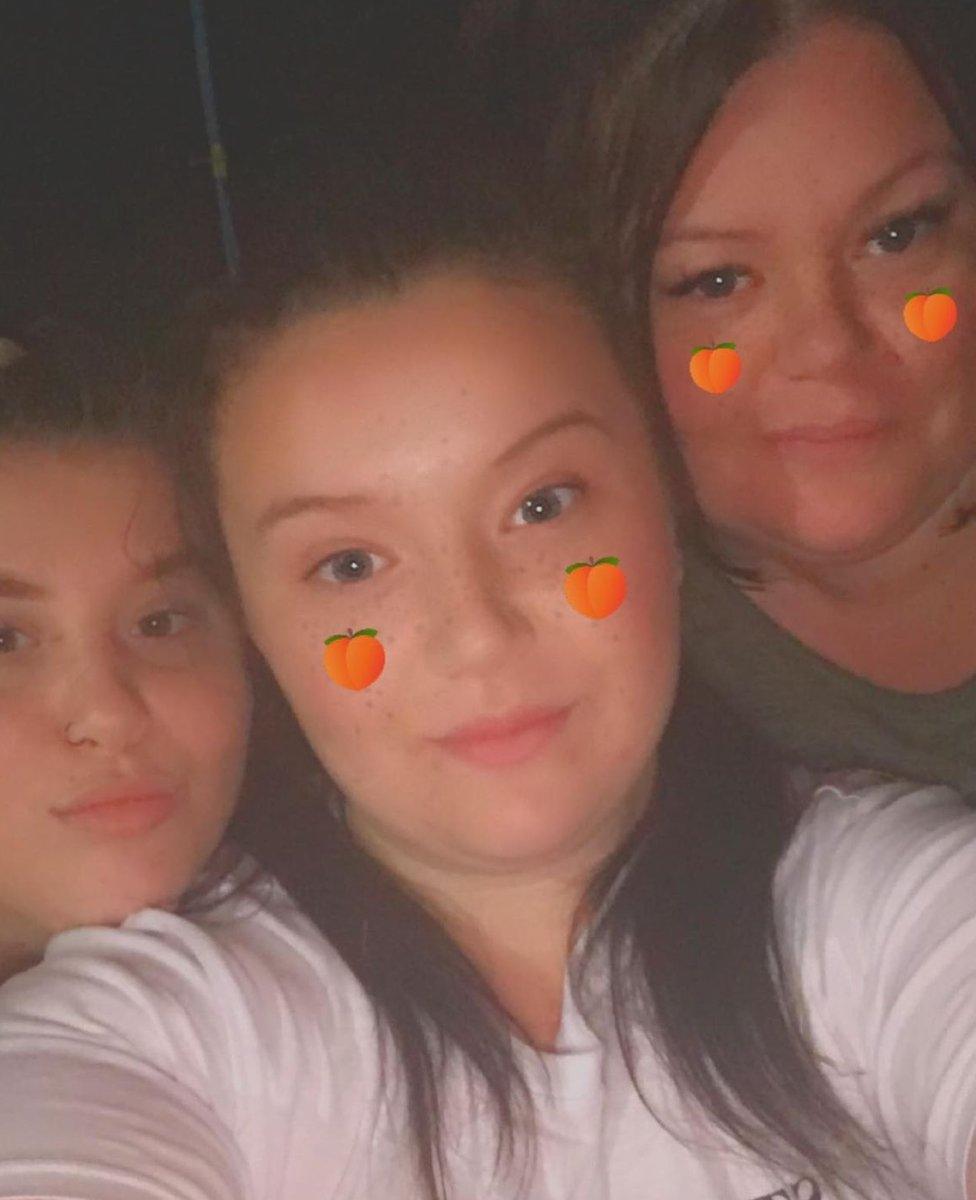 Amber (left) with her sister Holly (centre) and mum