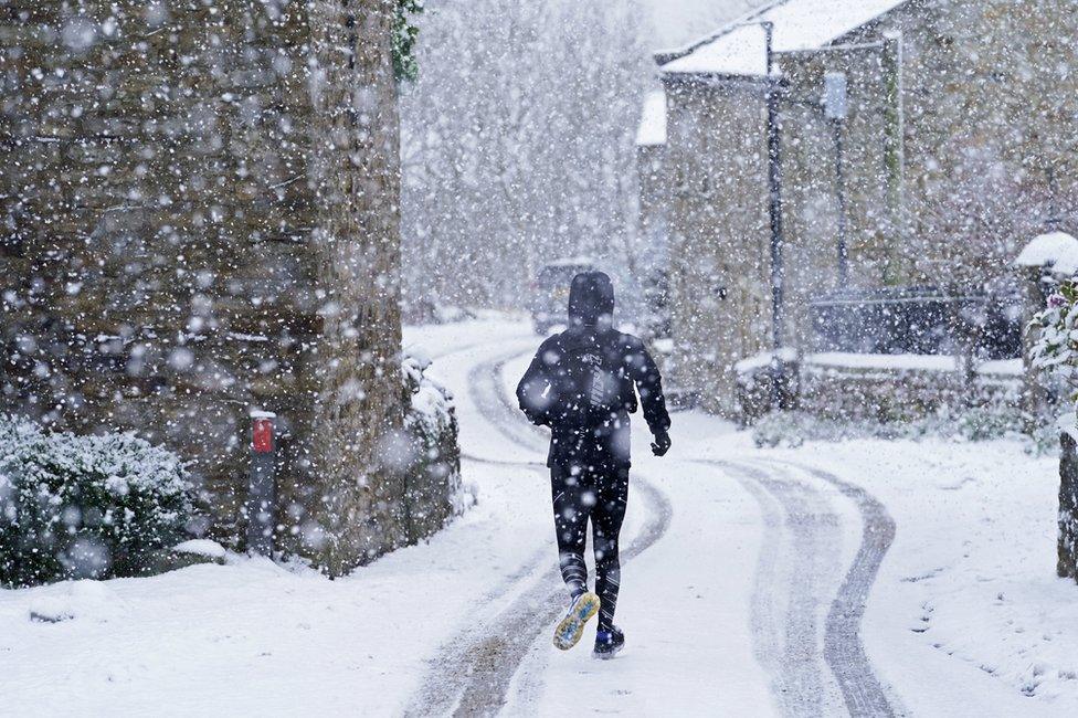 A man runs through the snow in Gunnerside, North Yorkshire. Picture date: Sunday November 28, 2021. PA Photo. Winter woollies will be needed amid freezing conditions in the aftermath of Storm Arwen which wreaked havoc across much of the UK. Temperatures were expected to struggle to get above freezing in some parts, with minus 1C (33.8F) forecast in some areas