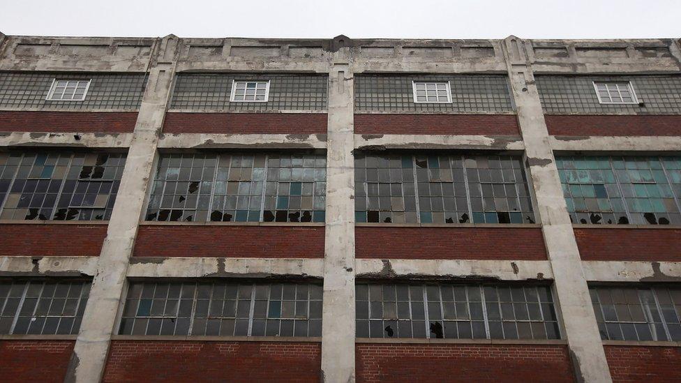 Broken windows mar the front of the long-closed Packard Electric factory on October 29, 2012 in Warren, Ohio.