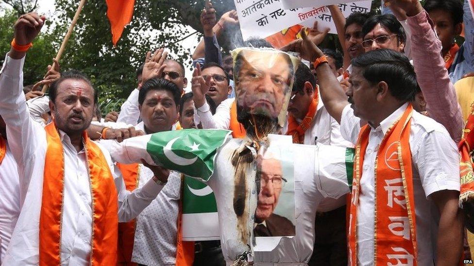 Activists of India's right-wing Shiv Sena burn an effigy depicting Pakistani Prime Minister Nawaz Sharif and his advisor on National Security and Foreign Affairs Sartaj Aziz