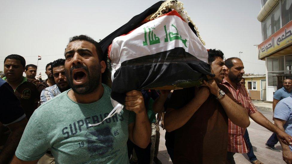 Iraqi men carry a coffin in the holy Iraqi city of Najaf on July 3, 2016