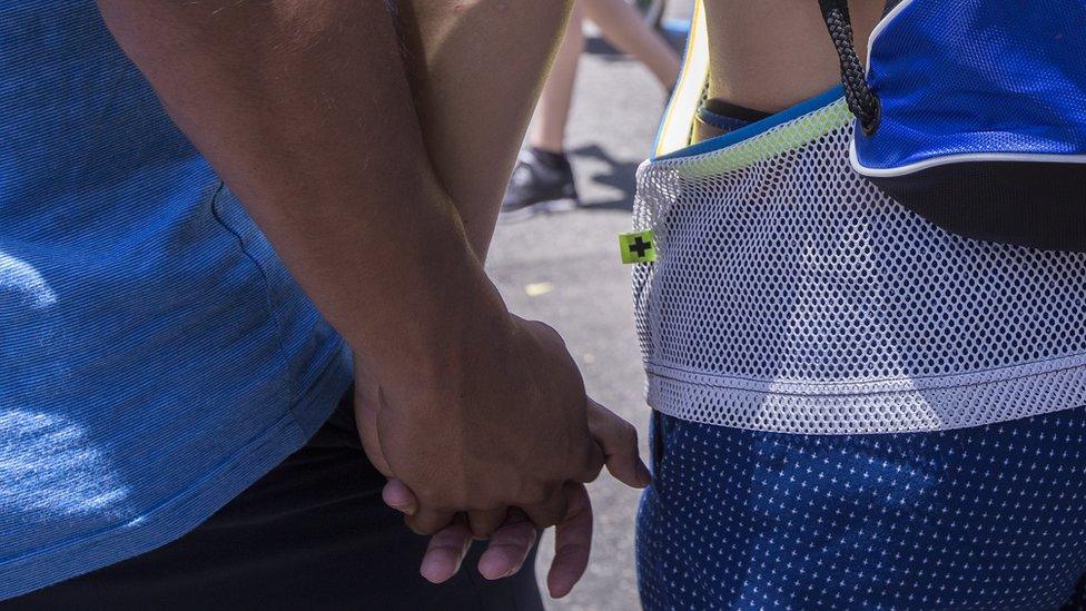 A couple holding hands (stock image)