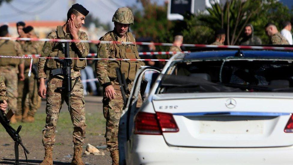 Lebanese soldiers inspecting a wrecked car following a drone strike on Saturday