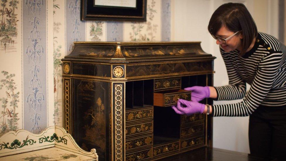 Curator Ruth Martin with a 260-year-old Chippendale secretaire