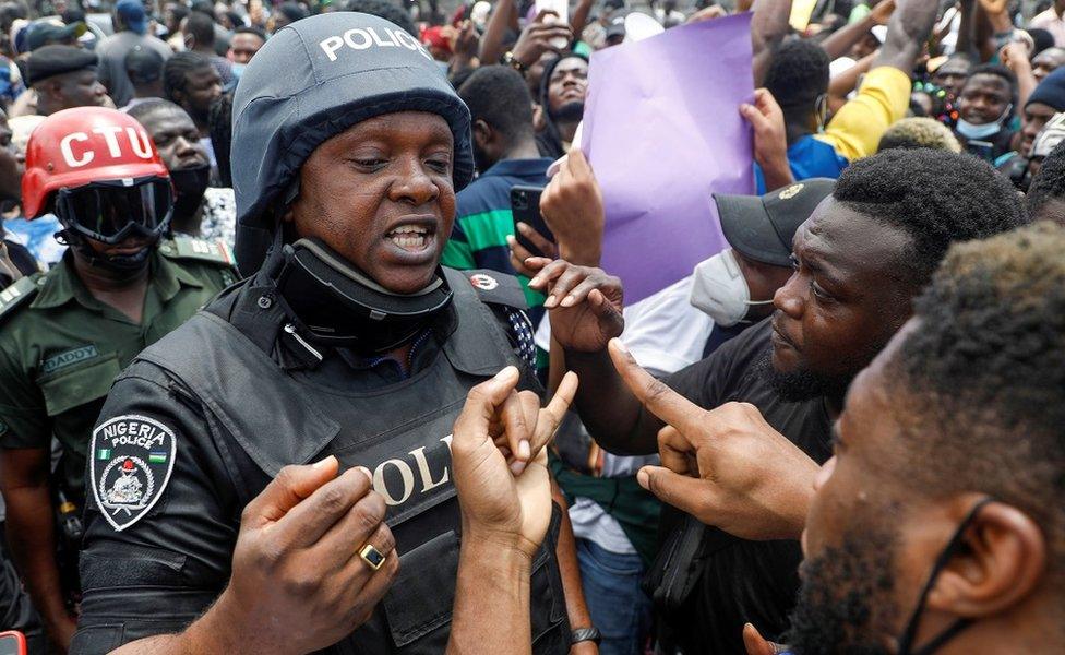 Policeman talking to protesters