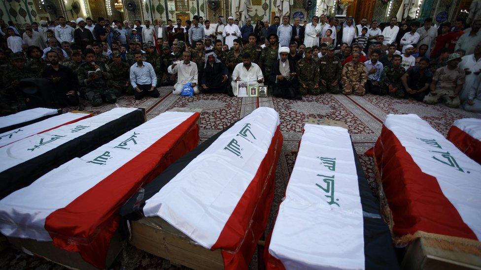 A funeral ceremony for some of the people killed in the Camp Speicher massacre