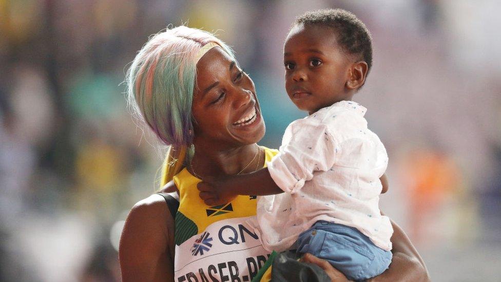 Shelly-Ann-Fraser-Pryce-holding-son.