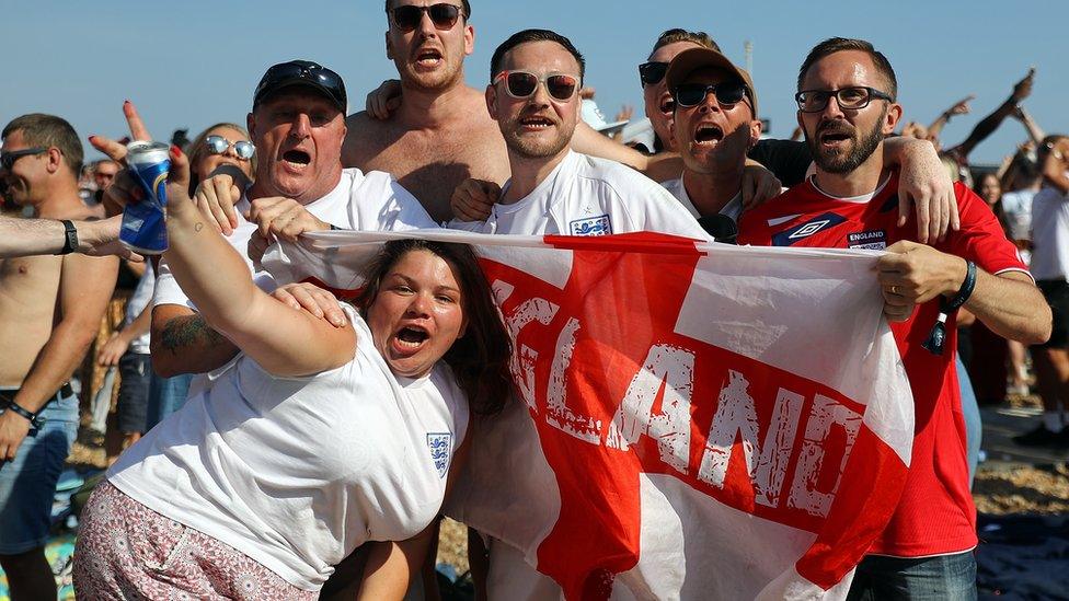 Football fans watch England take on Sweden in The World Cup Quarter Finals at Luna Beach Cinema on Brighton Beach