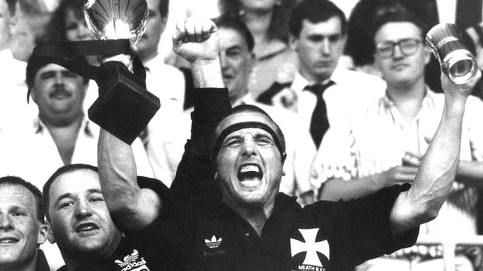 Neath captain Kevin Phillips lifts the Schweppes Cup in 1990