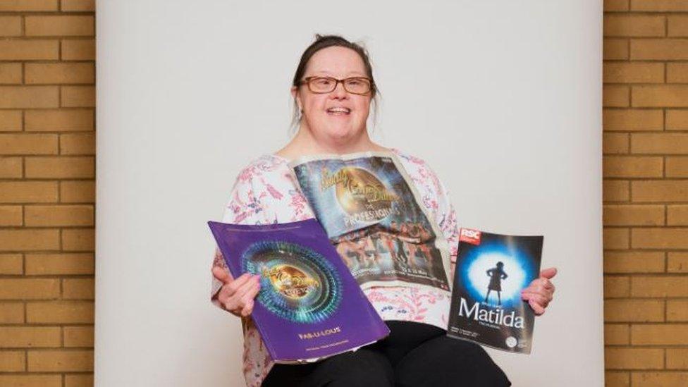 Marie Alderman holding her theatre programmes