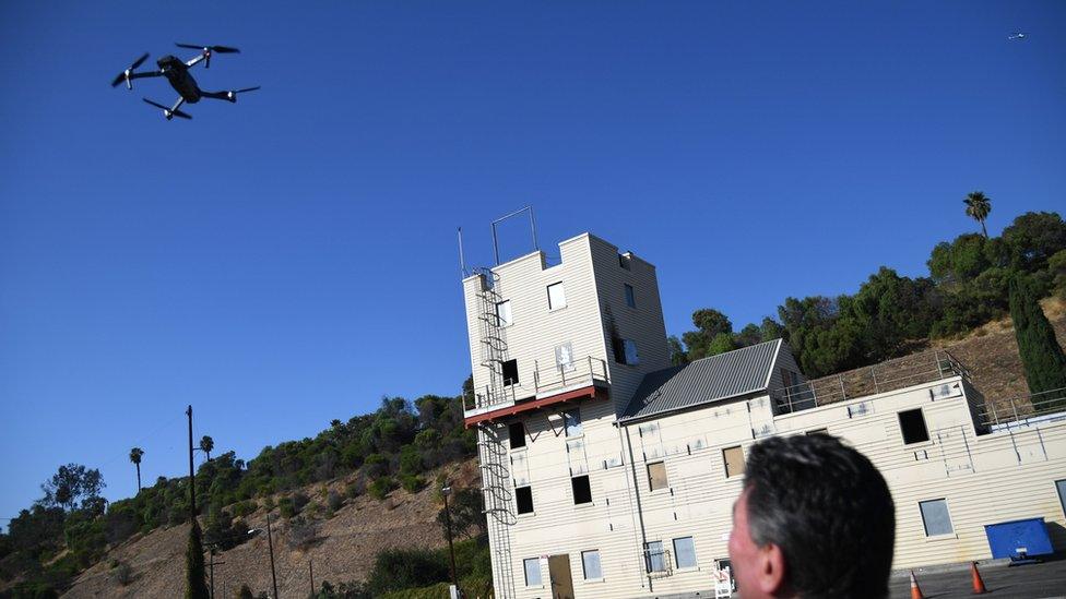 Drone flying with man wiatching