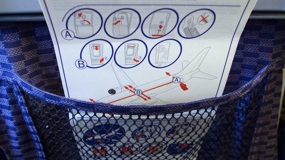 An aeroplane safety card explaining how to exit the